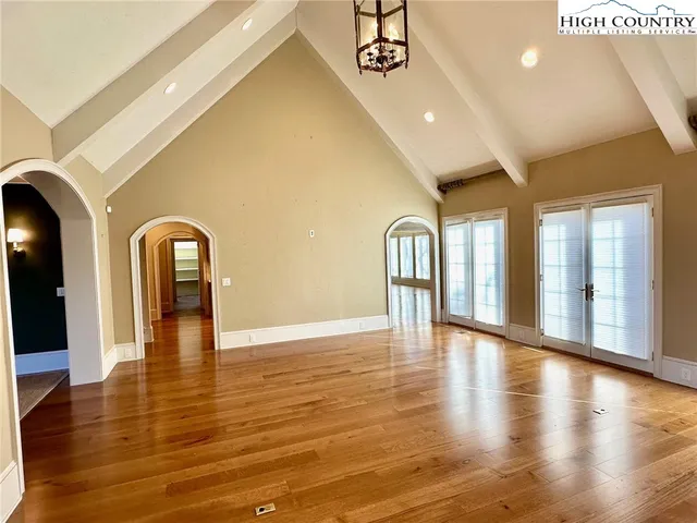 a view of lobby with chandelier and wooden floor