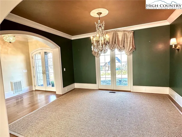 a view of an empty room with a chandelier
