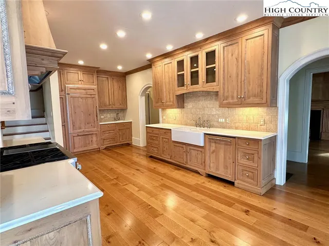 a kitchen with stainless steel appliances granite countertop a refrigerator and a stove top oven