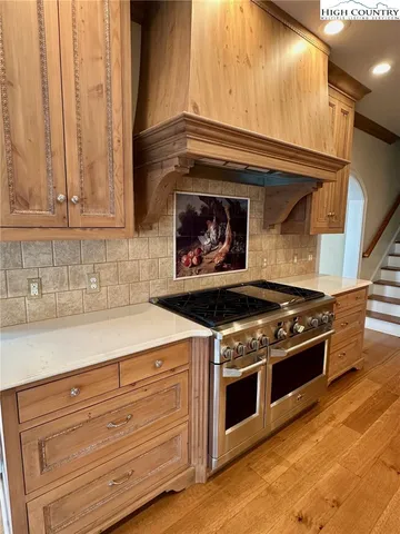 a stove top oven sitting inside of a kitchen
