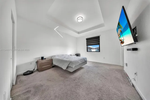 a bedroom with furniture and a flat screen tv