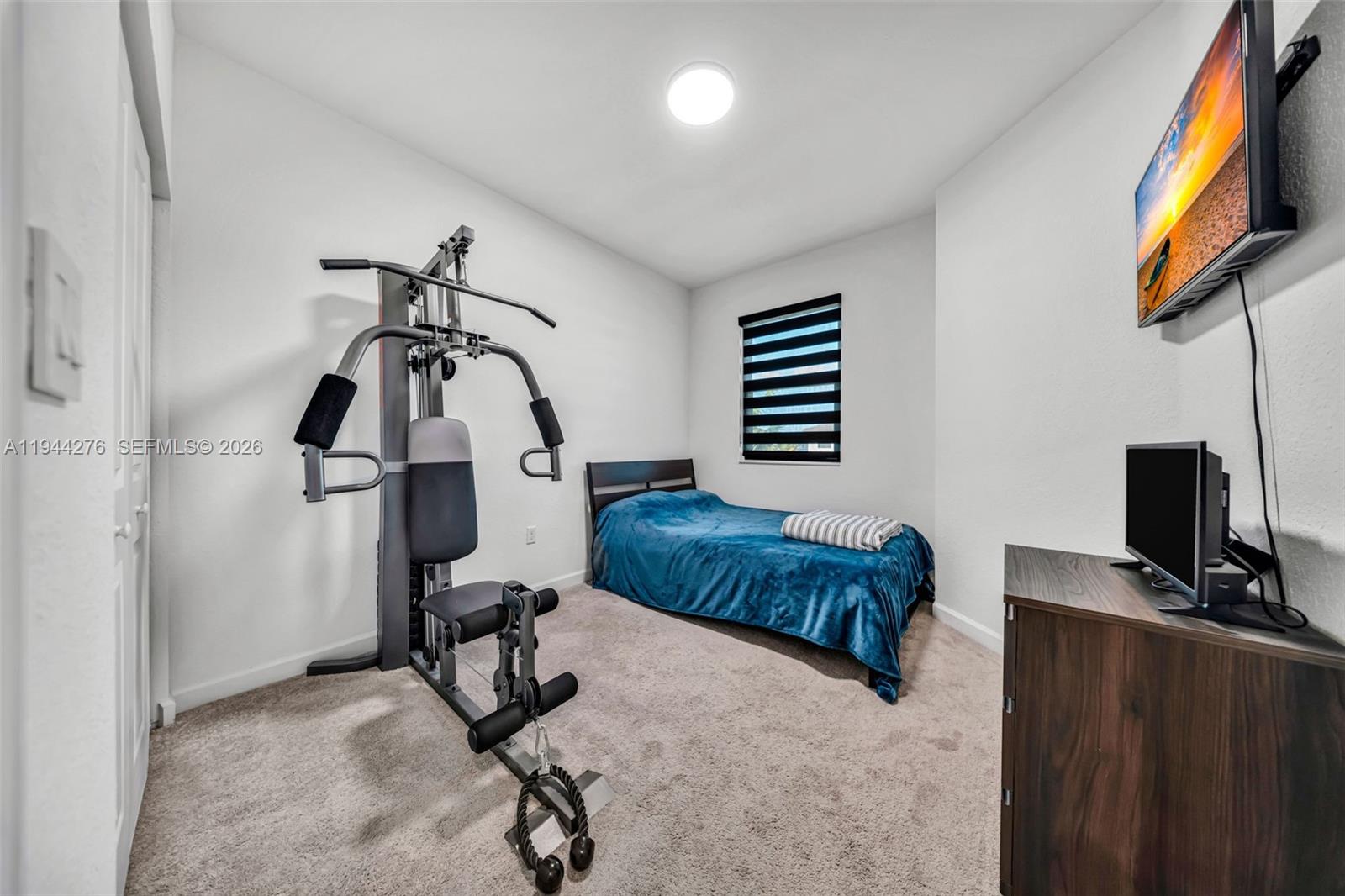 24985 Southwest 107th Court Homestead, FL 33032 - Photo 15 of 22 a bedroom with furniture and a window