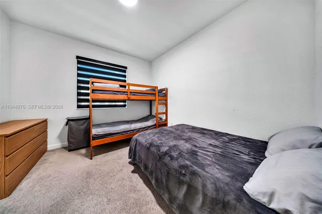 a bedroom with a bed and cabinets