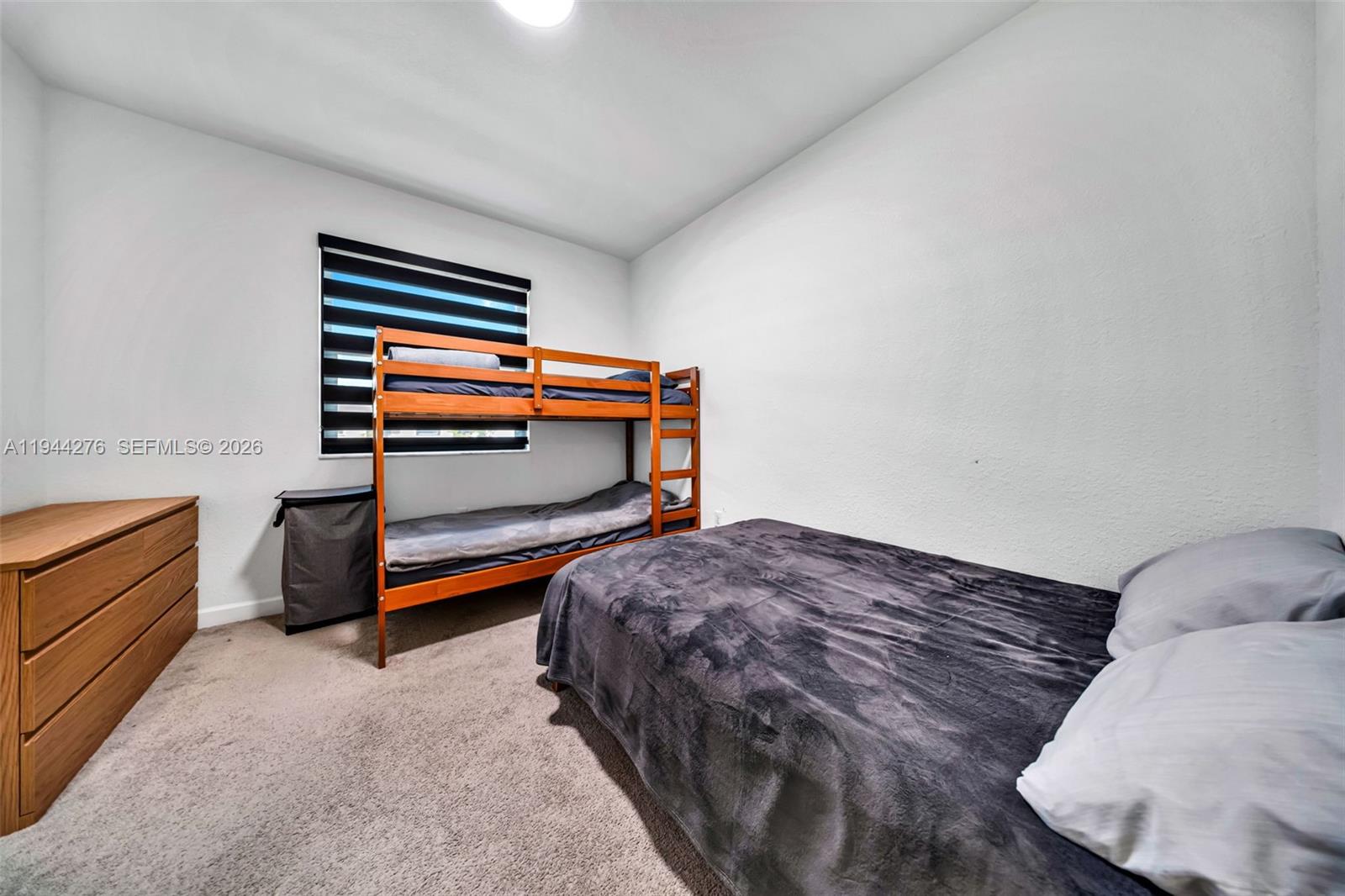 24985 Southwest 107th Court Homestead, FL 33032 - Photo 16 of 22 a bedroom with a bed and cabinets