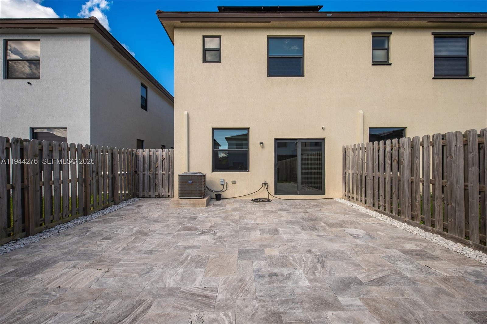 24985 Southwest 107th Court Homestead, FL 33032 - Photo 19 of 22 a view of a house with wooden fence and a refrigerator