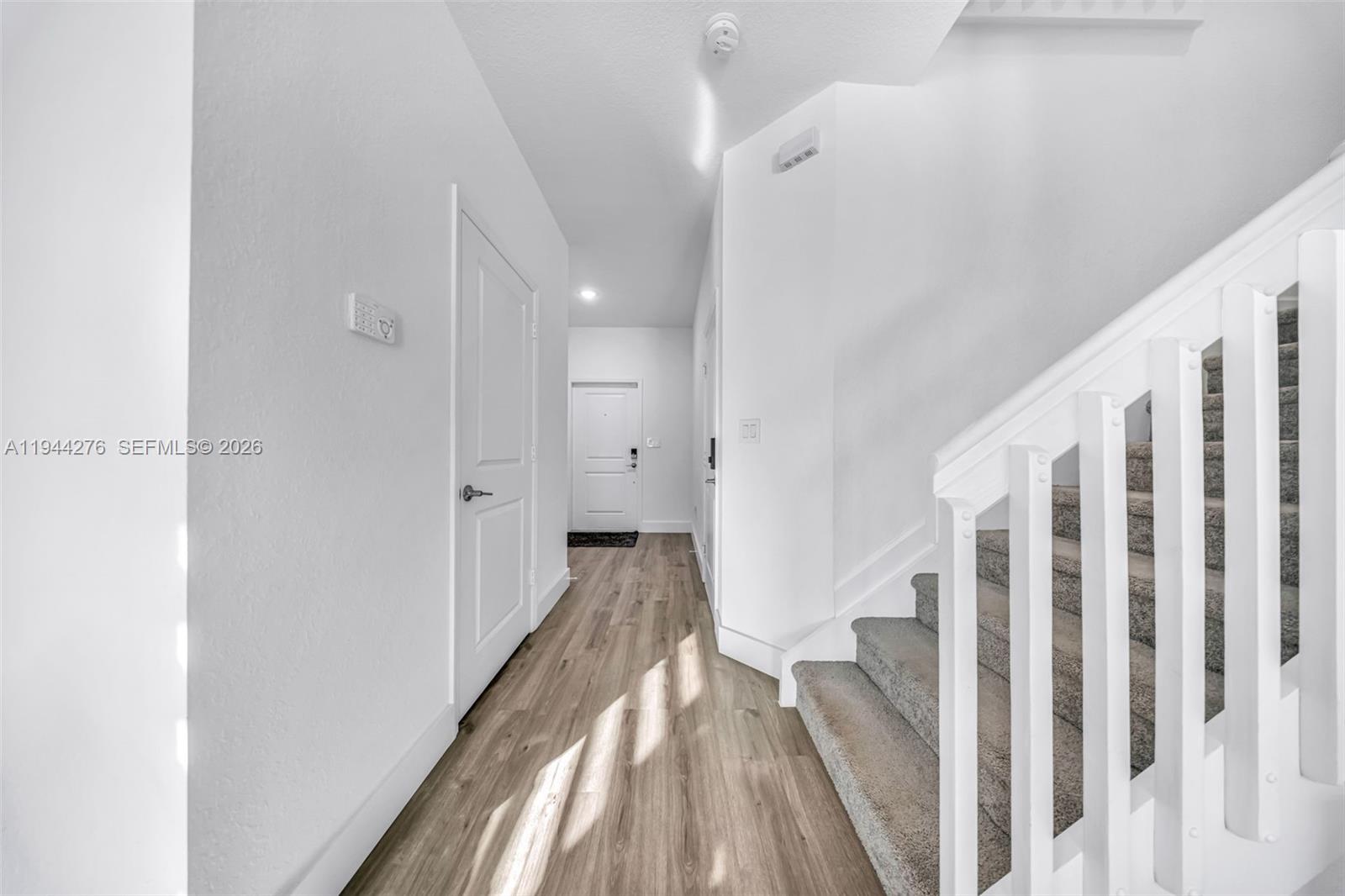 24985 Southwest 107th Court Homestead, FL 33032 - Photo 4 of 22 a view of a hallway with wooden floor and entryway