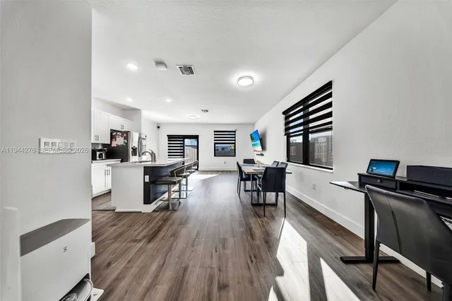 a view of a dining room with furniture window and wooden floor