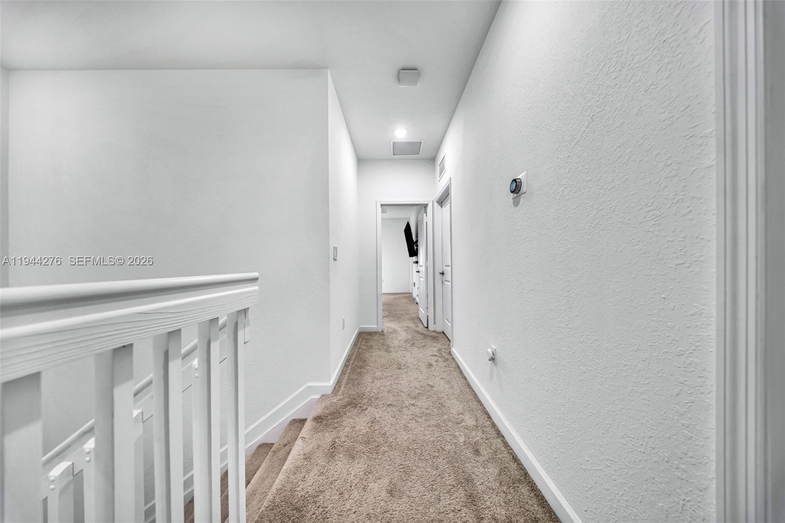 24985 Southwest 107th Court Homestead, FL 33032 - Photo 10 of 22 a view of a hallway with wooden floor