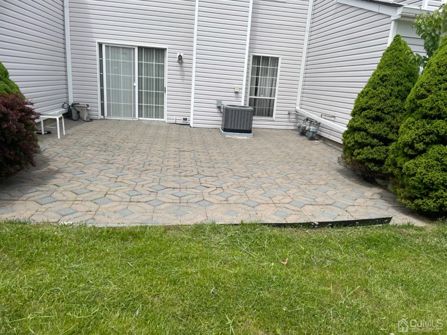 333 Devon Place Morganville, NJ 07751 - Photo 15 of 17 a view of a house with a yard and sitting area