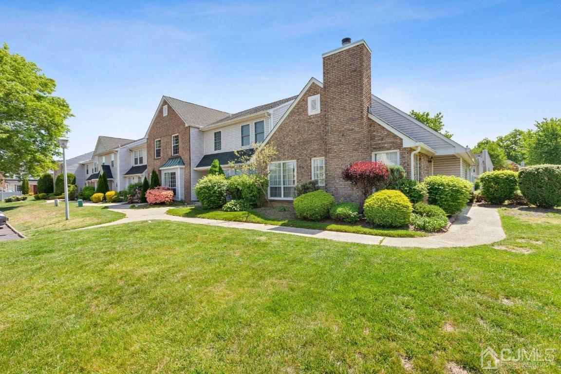 333 Devon Place Morganville, NJ 07751 - Photo 2 of 17 a front view of a house with a yard and garage