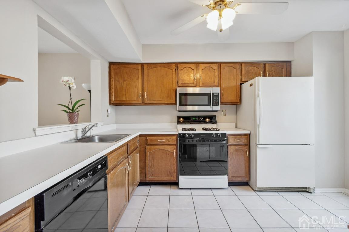 333 Devon Place Morganville, NJ 07751 - Photo 6 of 17 a kitchen with a sink appliances and cabinets