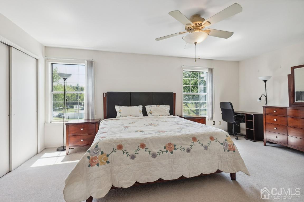 333 Devon Place Morganville, NJ 07751 - Photo 9 of 17 a bedroom with a bed chandelier and a window
