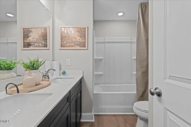 a bathroom with a tub sink toilet and a mirror