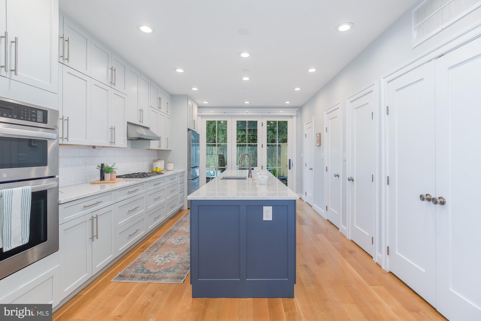 420 4th Street Southeast Washington, DC 20003 - Photo 12 of 31 a large kitchen with kitchen island a sink stainless steel appliances and cabinets