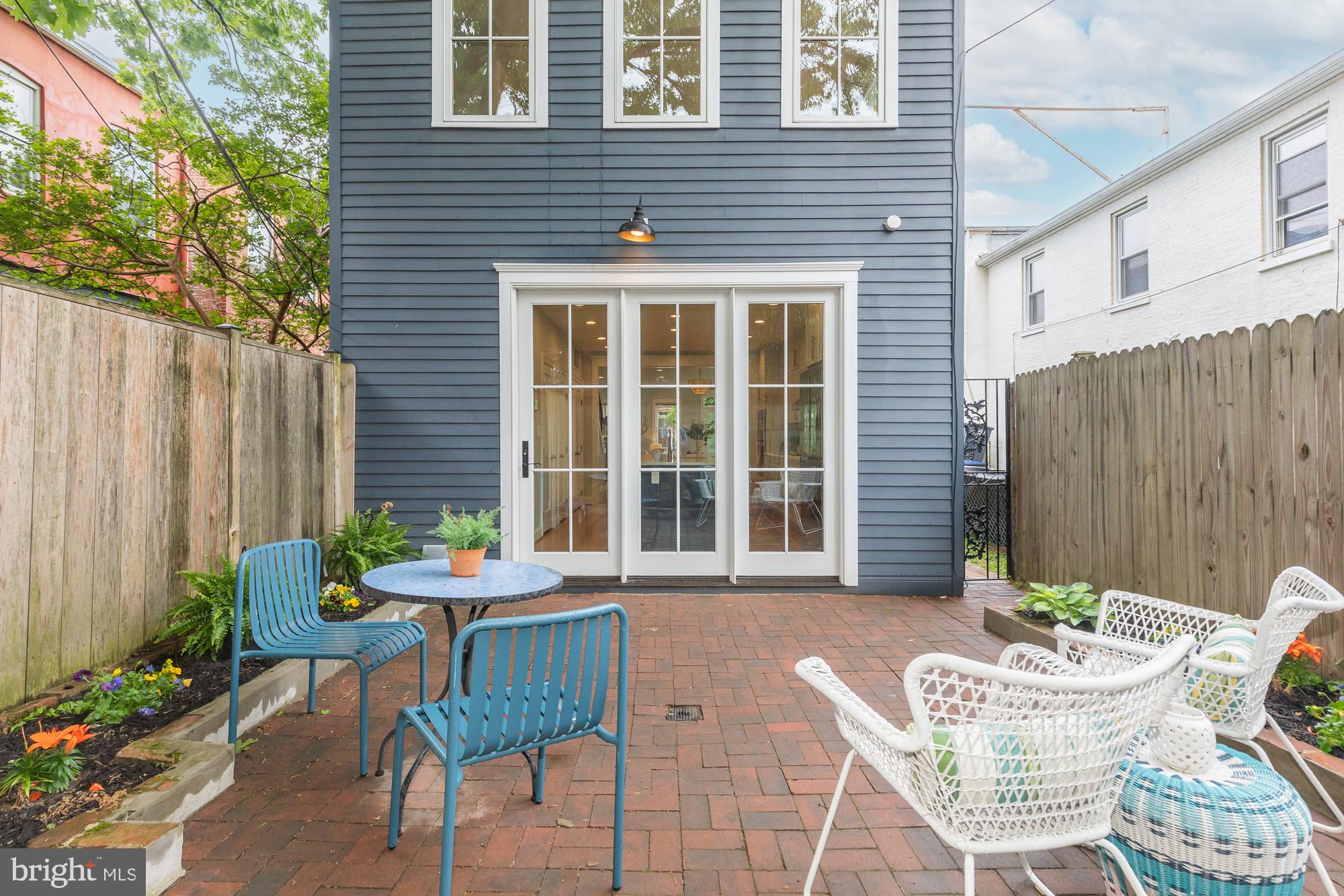 420 4th Street Southeast Washington, DC 20003 - Photo 18 of 31 a patio with a table and chairs and potted plants
