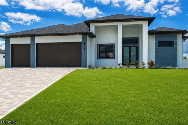a front view of a house with a yard and garage