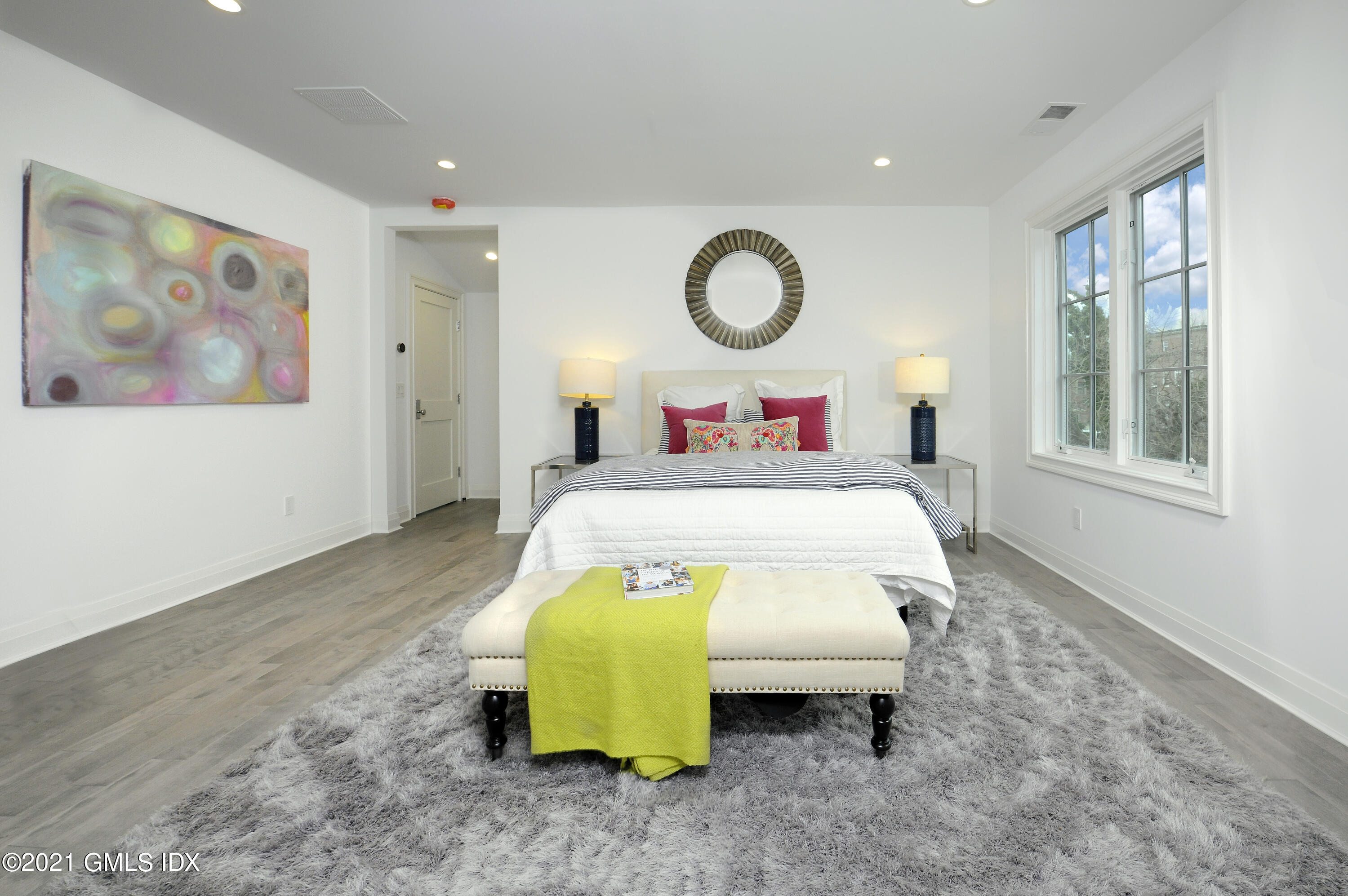 36 Washington Avenue Greenwich, CT 06830 - Photo 19 of 32 a bed room with a bed and painting on the wall