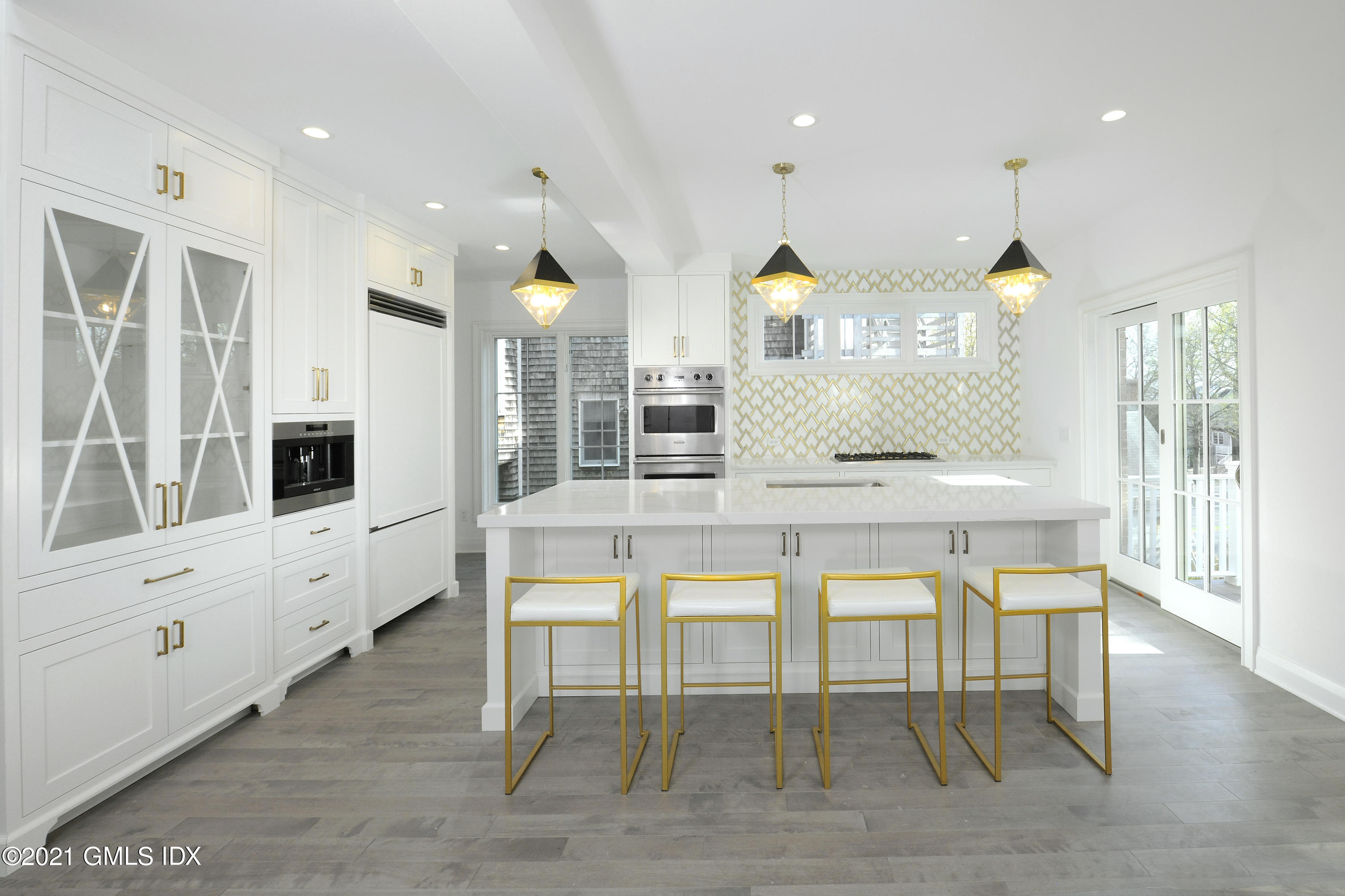 36 Washington Avenue Greenwich, CT 06830 - Photo 9 of 32 a kitchen with table chairs cabinets and wooden floor