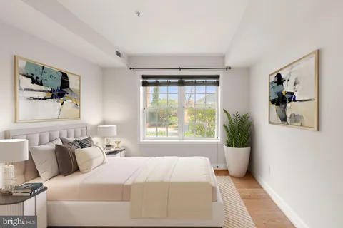 a bedroom with a large bed and a window