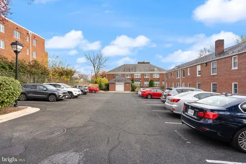 a view of city street with a cars parked in front of it