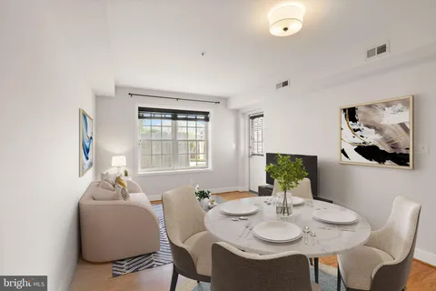 a view of a dining room with furniture and window