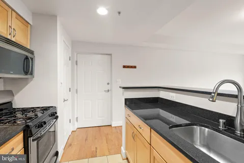 a kitchen that has a sink and a stove