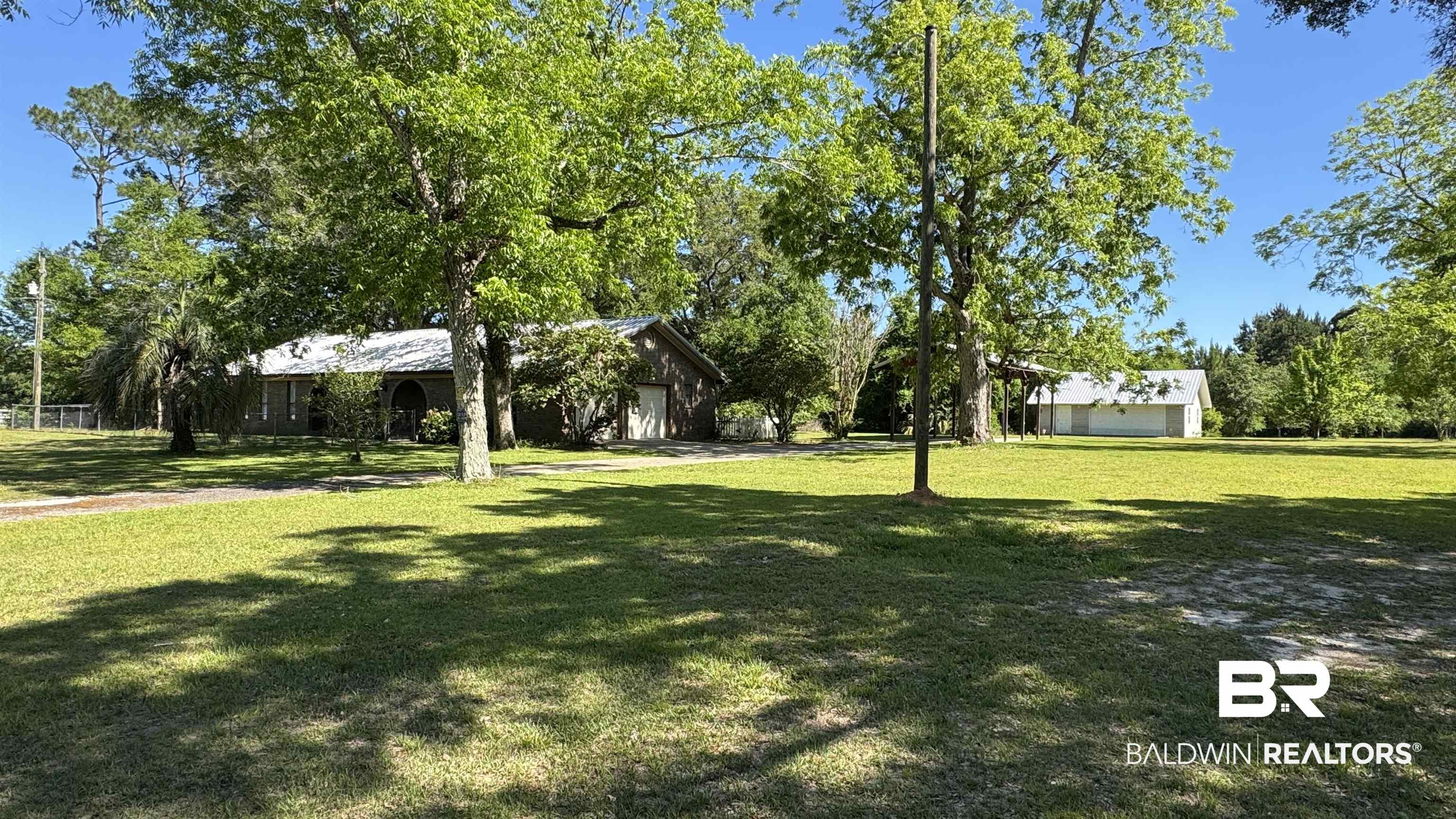 33370 Highway 98 Lillian, AL 36549 - Photo 17 of 58 Expansive green lawn with mature shade trees surrounding the property