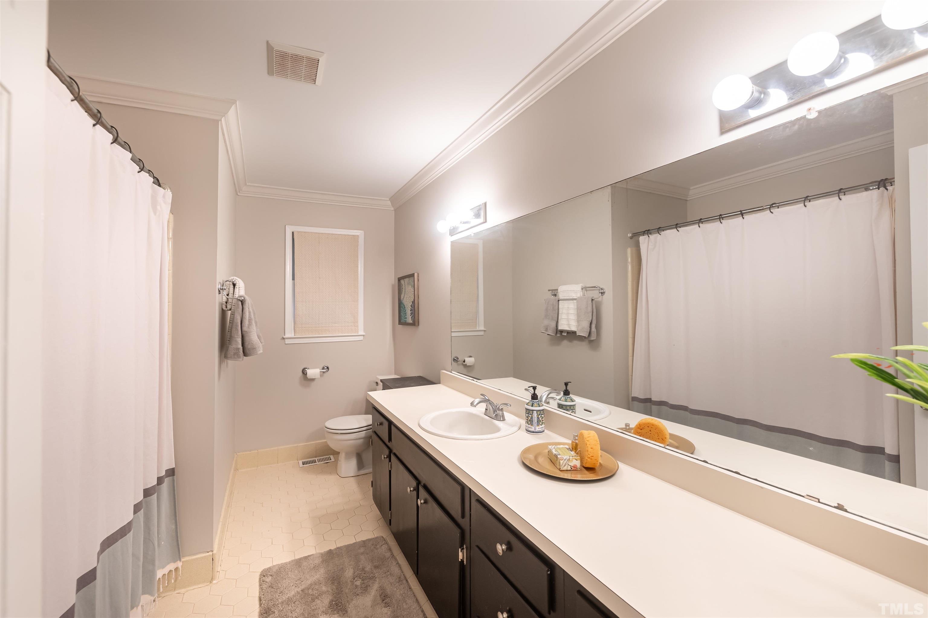 2612 Salisbury Plain Raleigh, NC 27613 - Photo 15 of 22 a bathroom with a granite countertop sink a large mirror and shower