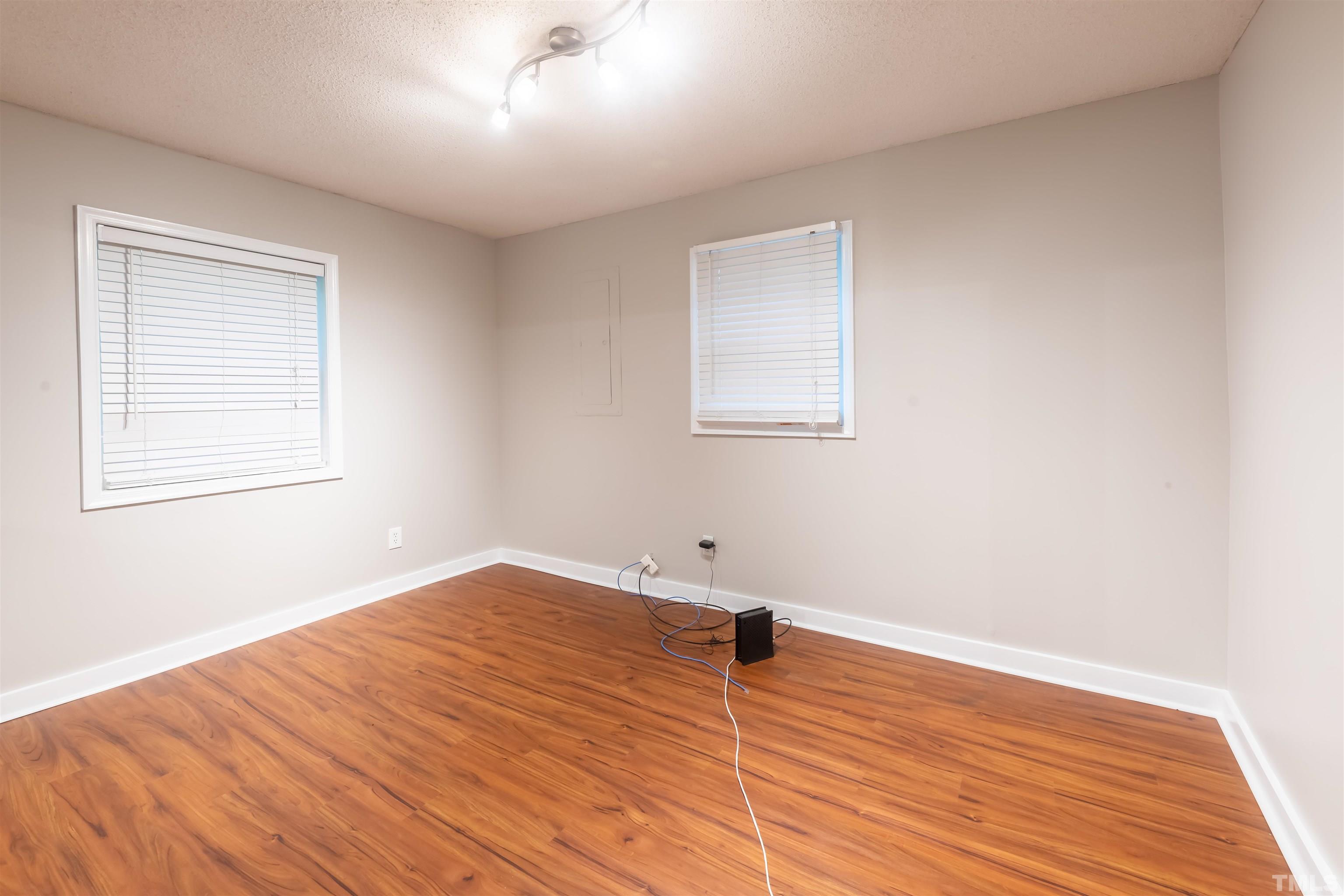 2612 Salisbury Plain Raleigh, NC 27613 - Photo 18 of 22 an empty room with wooden floor and windows