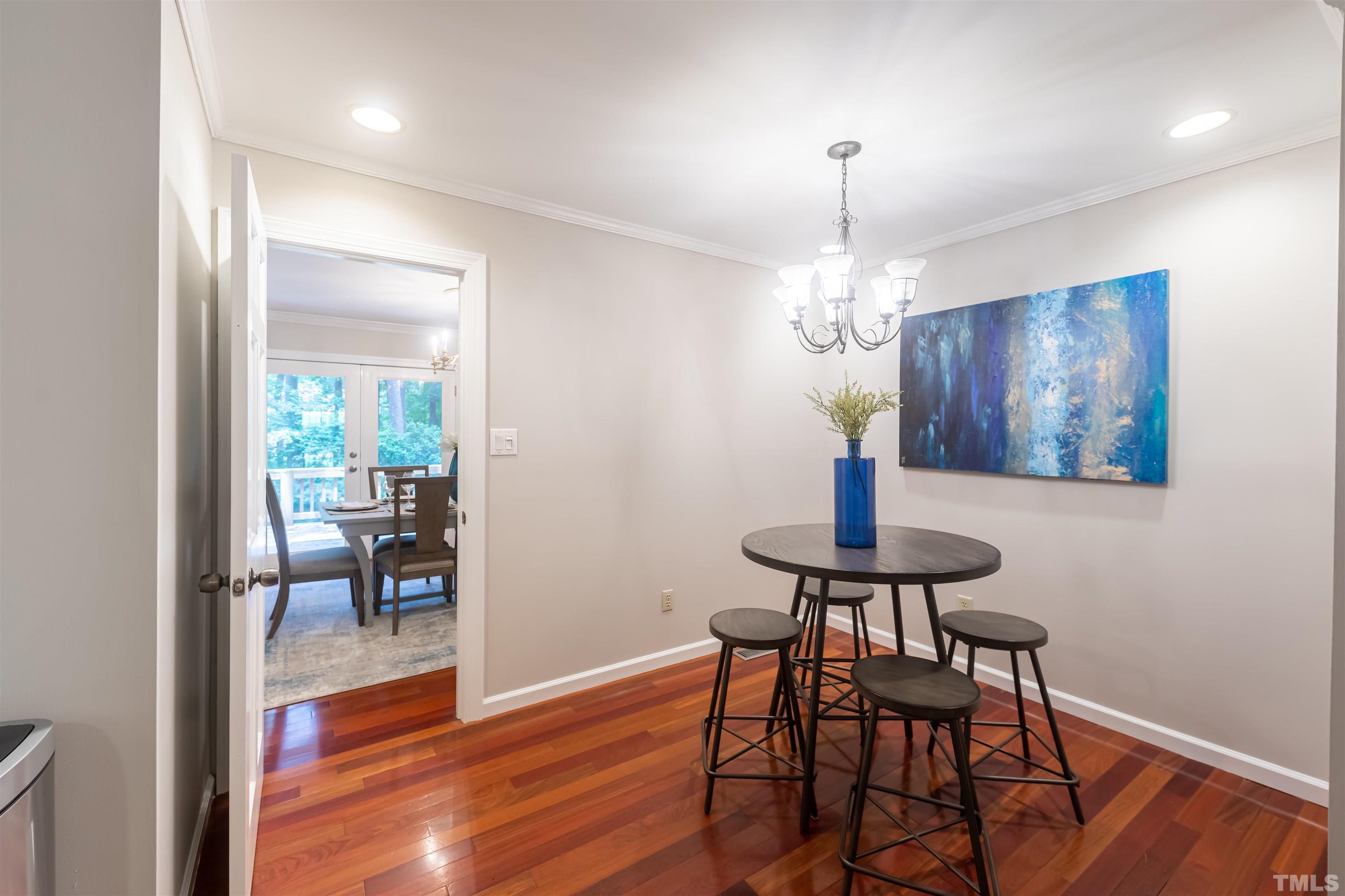 2612 Salisbury Plain Raleigh, NC 27613 - Photo 9 of 22 a view of a room with furniture wooden floor and chandelier