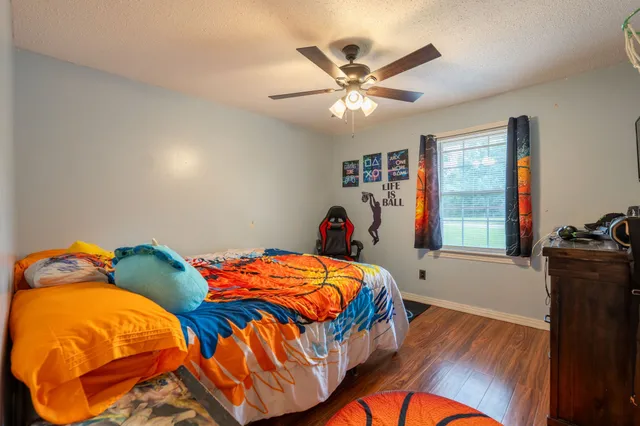 a bedroom with two beds and a window