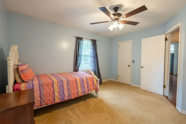 a bedroom with bed and window