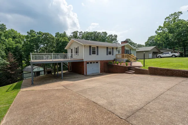 a front view of a house with a garden and sitting area