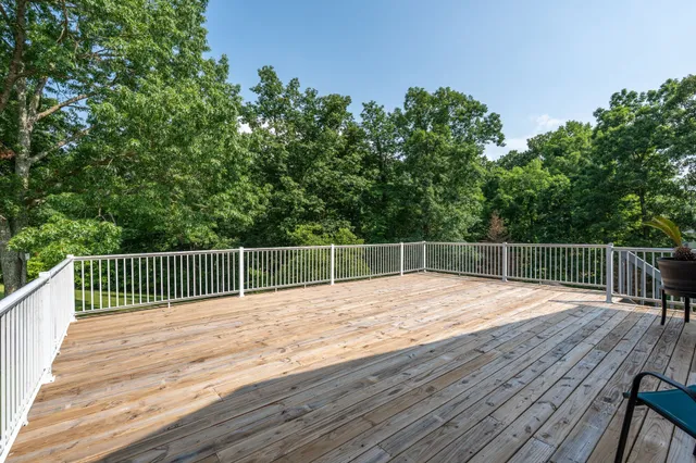 a balcony with wooden floor and fence