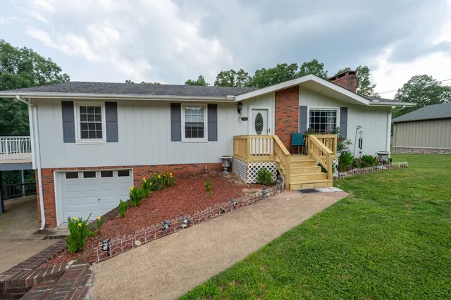 a view of a house with a yard and plants
