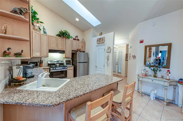 a kitchen with a sink dishwasher and white cabinets