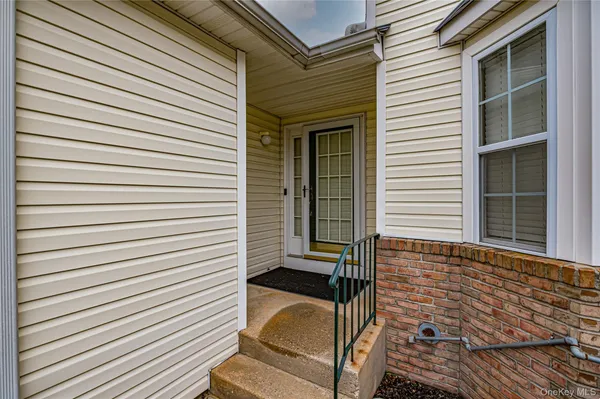 a view of a porch with a door and a window