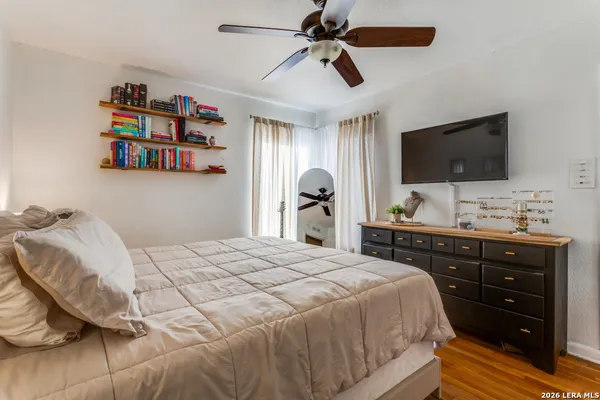 a bedroom with a bed and a flat screen tv