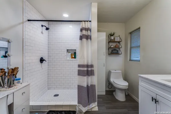 a bathroom with a shower toilet and sink