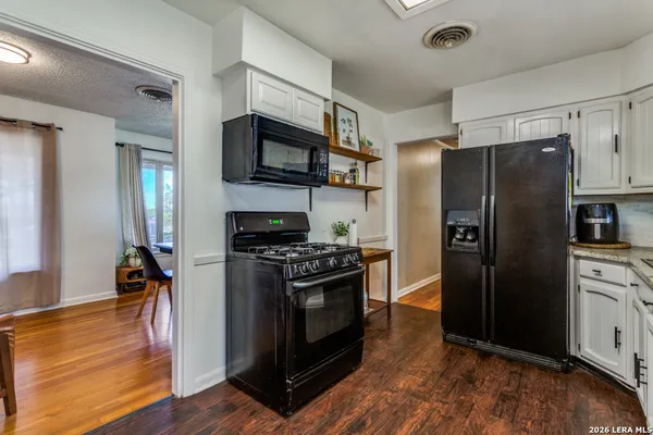 a kitchen with stainless steel appliances a refrigerator stove and microwave