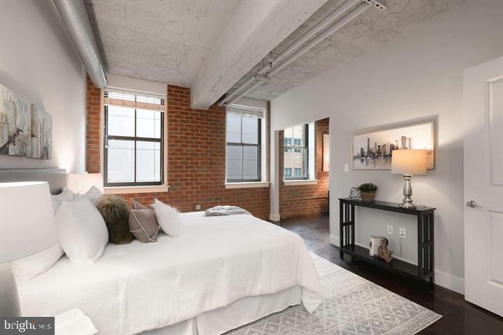 916 G St. Northwest, Unit 602 Washington, DC 20001 - Photo 8 of 11 a bedroom with a bed and wooden floor
