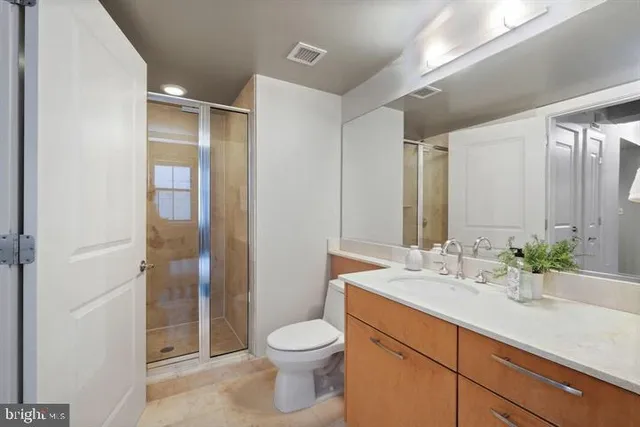 a bathroom with a double vanity sink toilet and shower