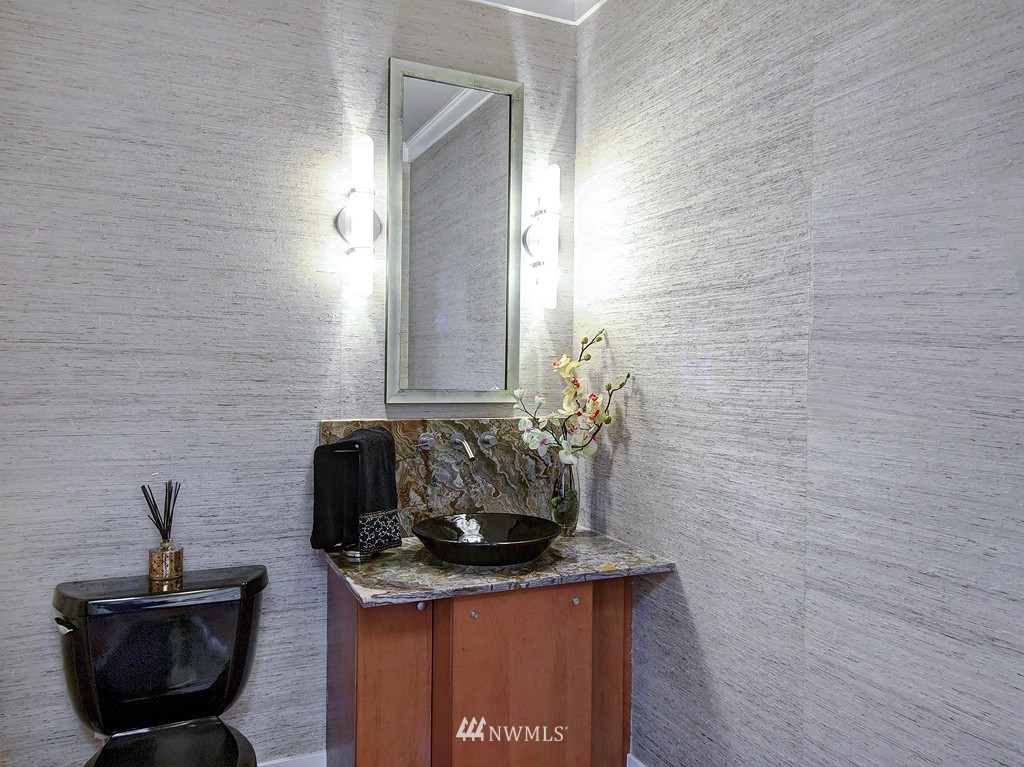 61 Pine Street, Unit 302 Edmonds, WA 98020 - Photo 12 of 25 a bathroom with a granite countertop sink a mirror and a toilet