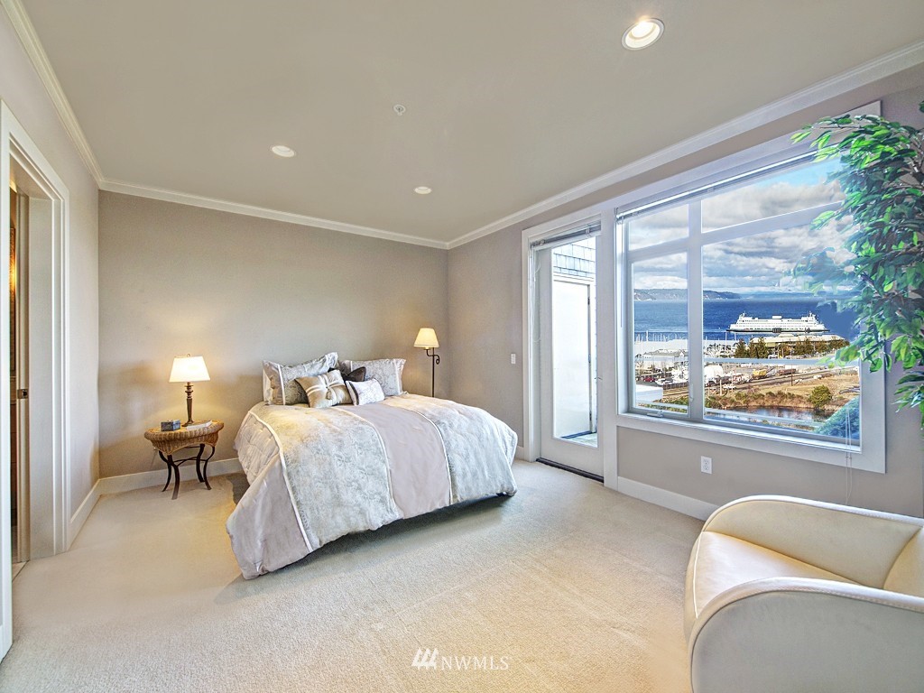 61 Pine Street, Unit 302 Edmonds, WA 98020 - Photo 15 of 25 a spacious bedroom with a bed and glass walk in closet