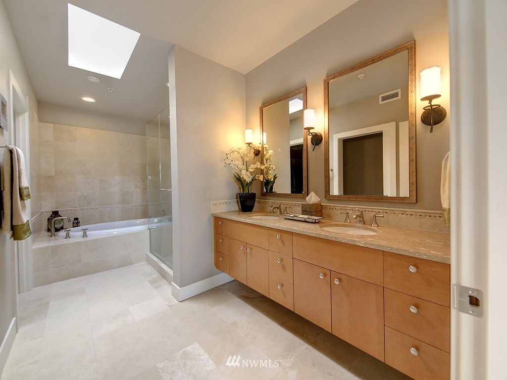 61 Pine Street, Unit 302 Edmonds, WA 98020 - Photo 16 of 25 a bathroom with a tub sink and mirror