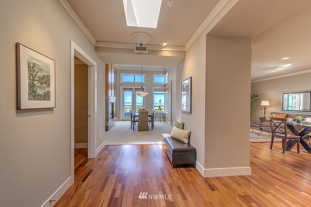 61 Pine Street, Unit 302 Edmonds, WA 98020 - Photo 3 of 25 a view of a hallway with wooden floor and a living room