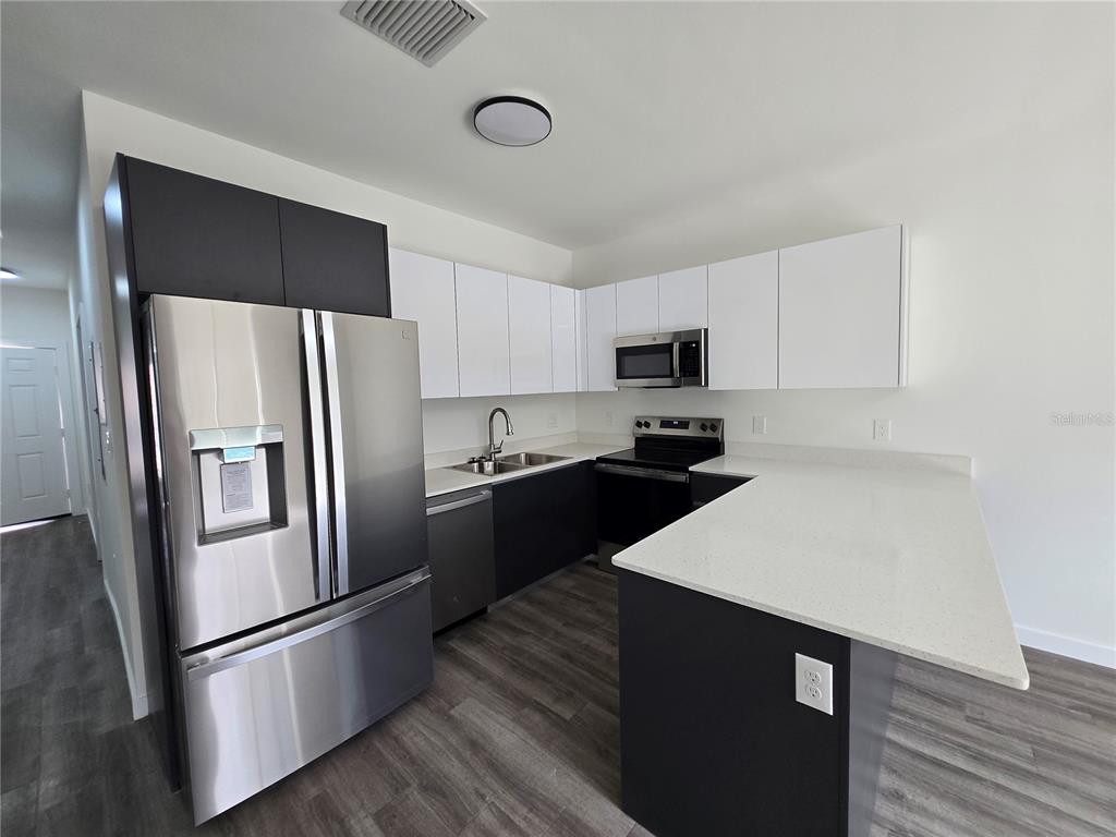1601 Northwest 29 Road, Unit 3 Gainesville, FL 32605 - Photo 14 of 48 a kitchen with a refrigerator stove and microwave