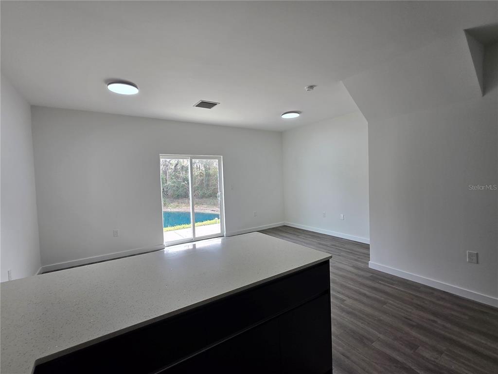 1601 Northwest 29 Road, Unit 3 Gainesville, FL 32605 - Photo 18 of 48 an empty room with wooden floor and windows