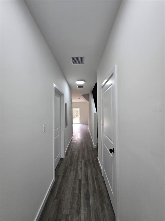 1601 Northwest 29 Road, Unit 3 Gainesville, FL 32605 - Photo 20 of 48 a view of a hallway with wooden floor and staircase
