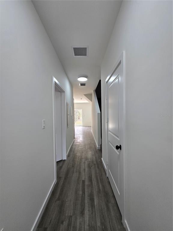 1601 Northwest 29 Road, Unit 3 Gainesville, FL 32605 - Photo 21 of 48 a view of a hallway with wooden floor